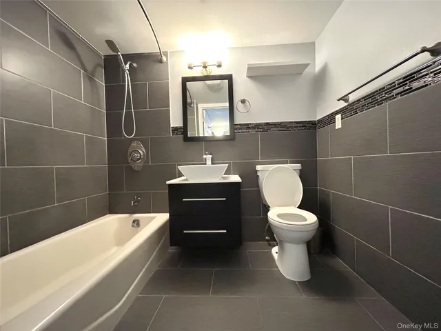 a bathroom with a toilet a sink and bathtub