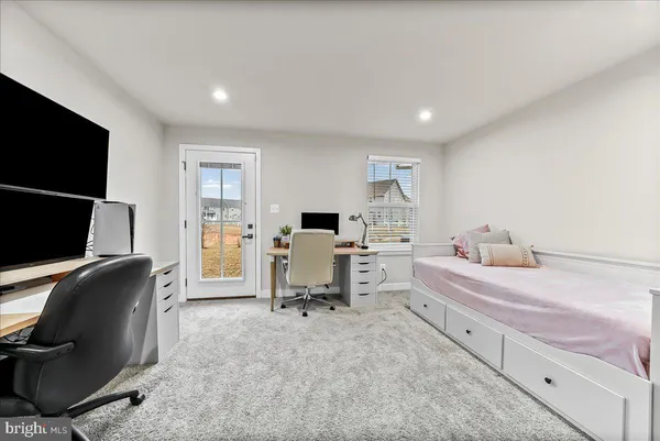 a bedroom with a workspace