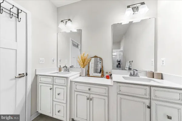 a bathroom with a double vanity sink and mirror