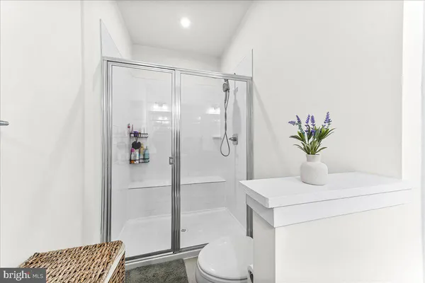 a bathroom with a shower a toilet and a sink
