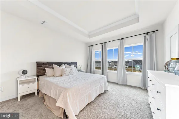 a spacious bedroom with a large bed and a large window