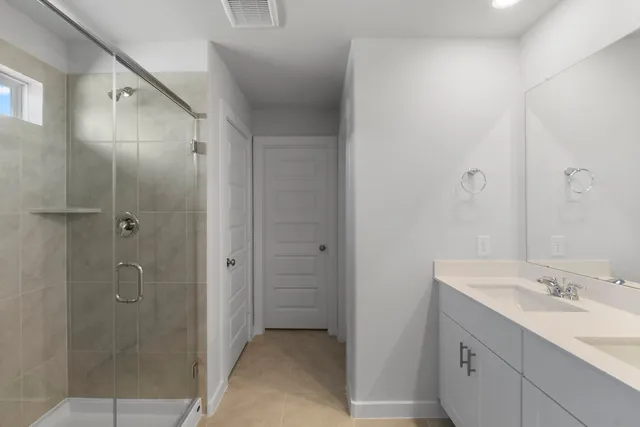 a bathroom with a shower sink and mirror