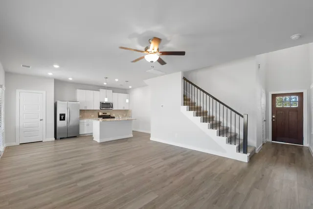 a view of kitchen with wooden floor and electronic appliances