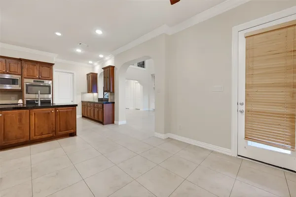 a spacious bathroom with a granite countertop sink mirror and a bathtub