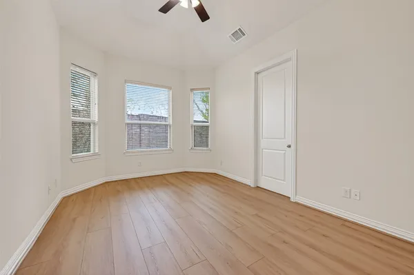 an empty room with a empty space and windows
