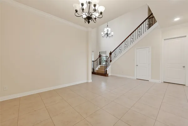an empty room with windows and fireplace
