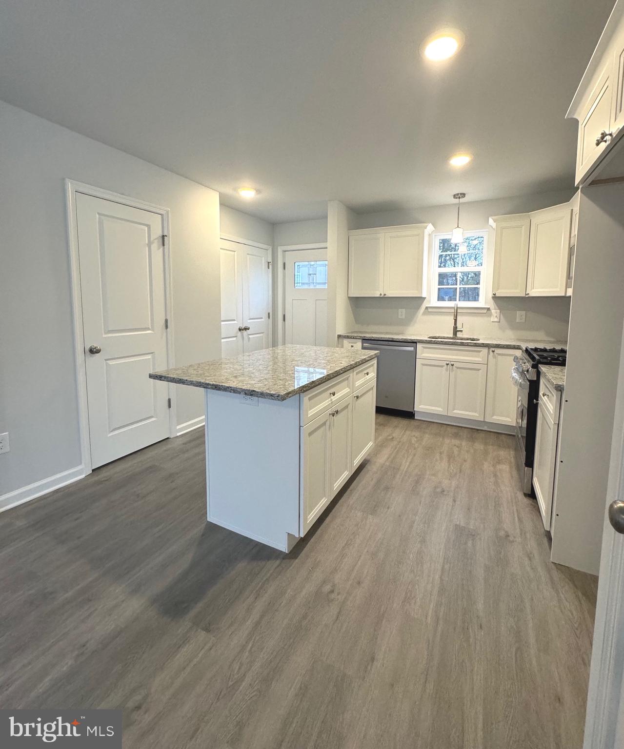 113 Henry Street Bridgeton, NJ 08302 - Photo 6 of 24 a large kitchen with a lot of counter space and wooden floor