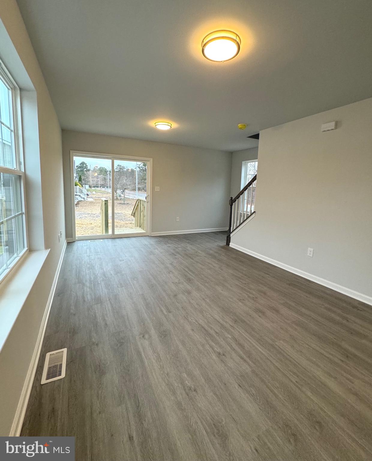 113 Henry Street Bridgeton, NJ 08302 - Photo 8 of 24 an empty room with wooden floor and windows
