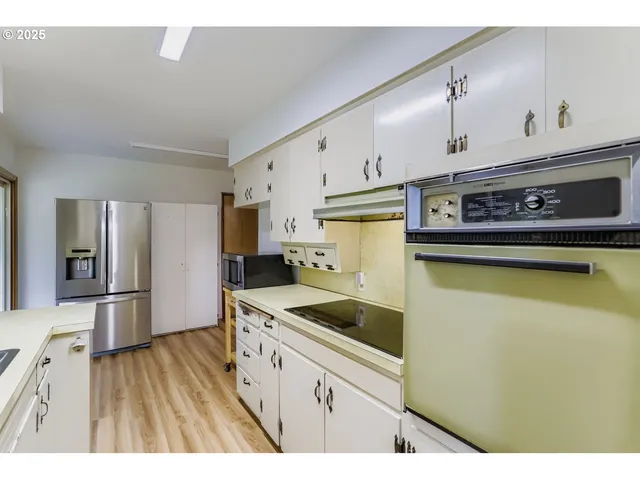 a kitchen with stainless steel appliances granite countertop a sink and a stove