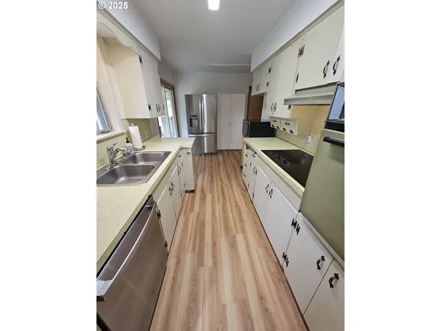 a kitchen with a sink stove and cabinets