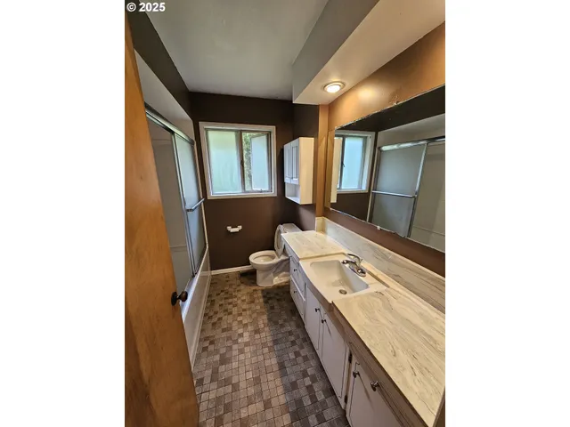 a spacious bathroom with a granite countertop sink and a large mirror