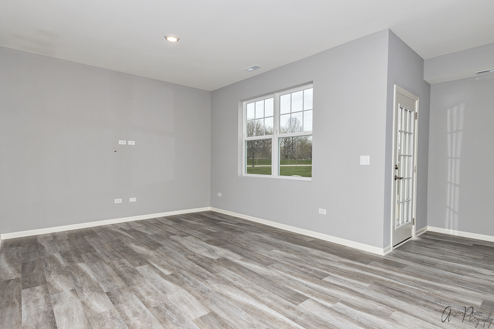 4012 Monica Lane, Unit 2 Johnsburg, IL 60051 - Photo 13 of 33 a view of an empty room with wooden floor and a window