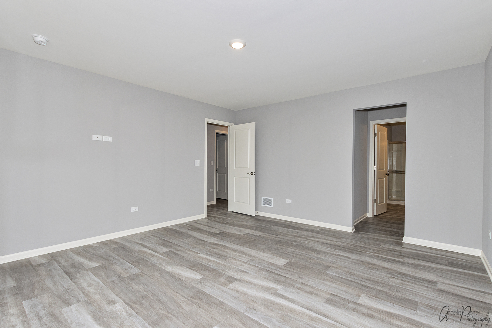 4012 Monica Lane, Unit 2 Johnsburg, IL 60051 - Photo 27 of 33 a view of an empty room with wooden floor