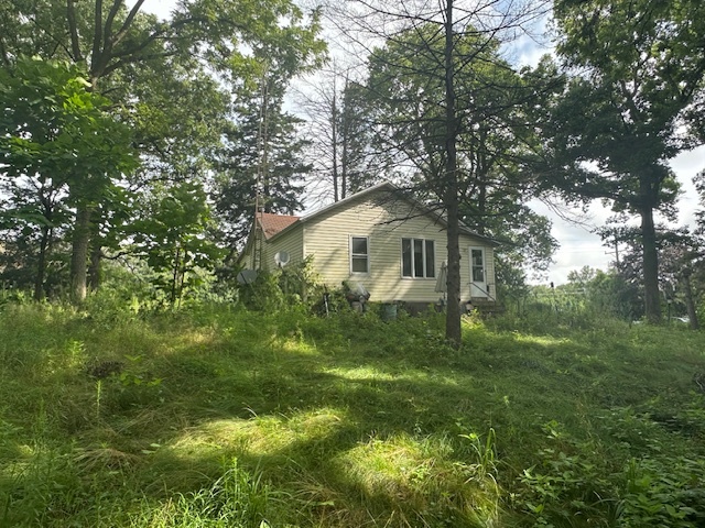 a yellow house with lots of trees