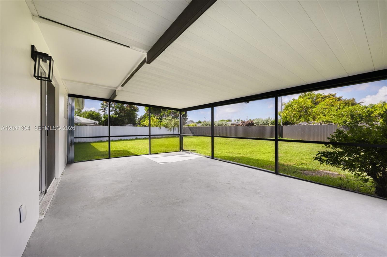 10340 Southwest 157th Street Miami, FL 33157 - Photo 18 of 24 Screened Patio – Covered and screened patio creates a comfortable outdoor living area with easy access to the backyard. An ideal setting for morning coffee or evening relaxation.