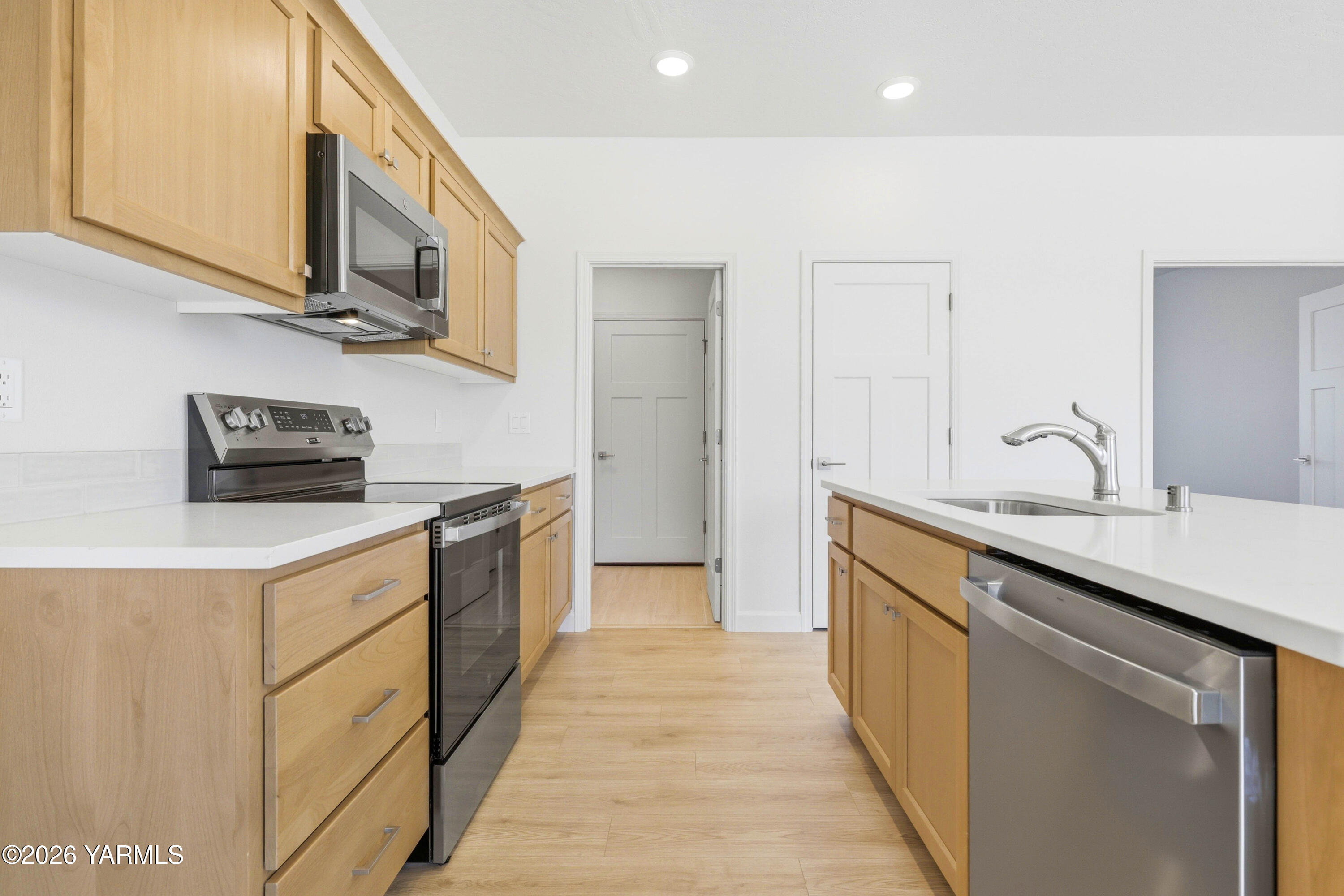 218 Packer Street Prosser, WA 99350 - Photo 7 of 36 a kitchen with stainless steel appliances a sink stove and cabinets