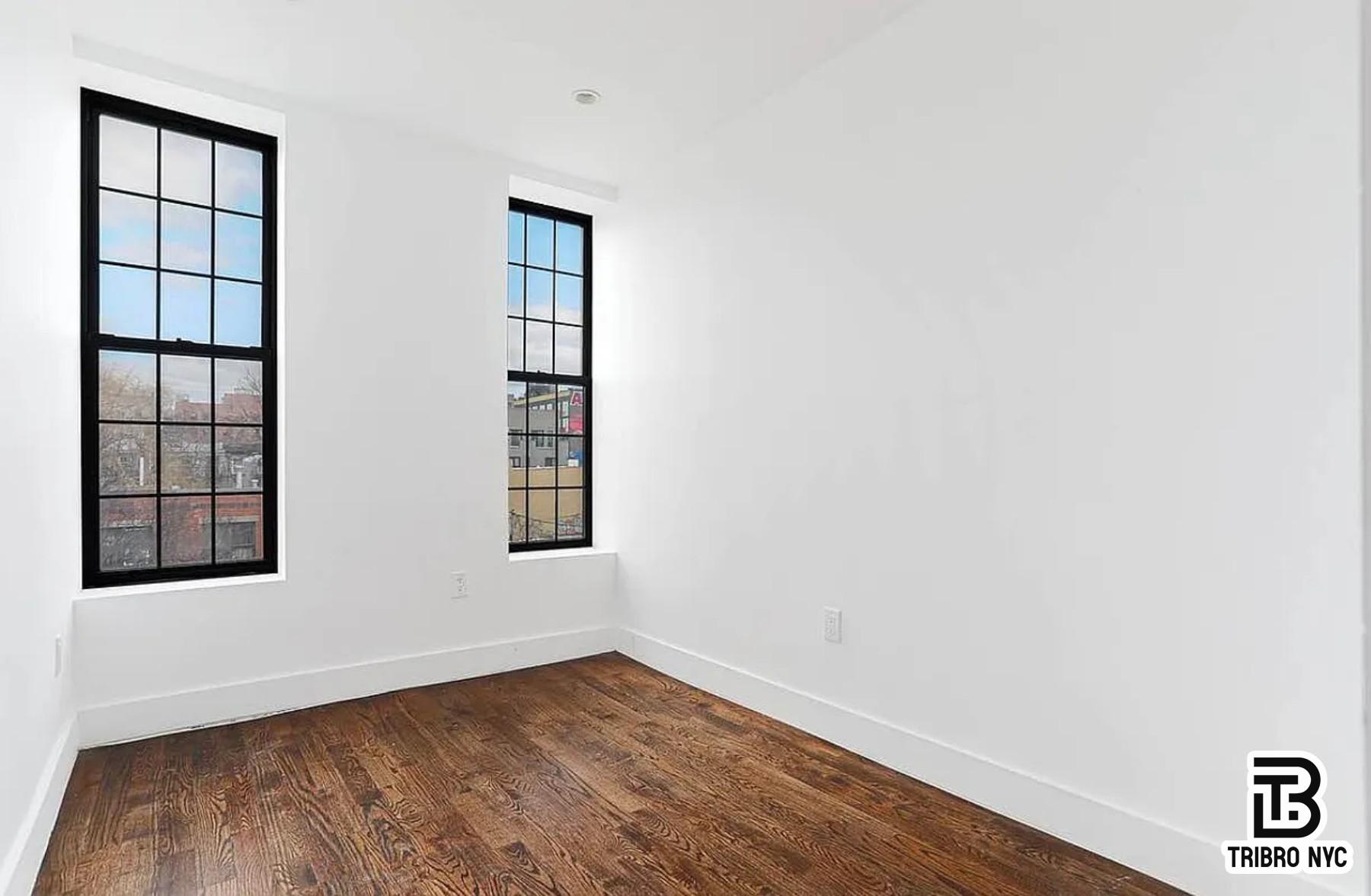 558 Kosciuszko Street, Unit 2R Brooklyn, NY 11221 - Photo 1 of 7 an empty room with wooden floor and windows