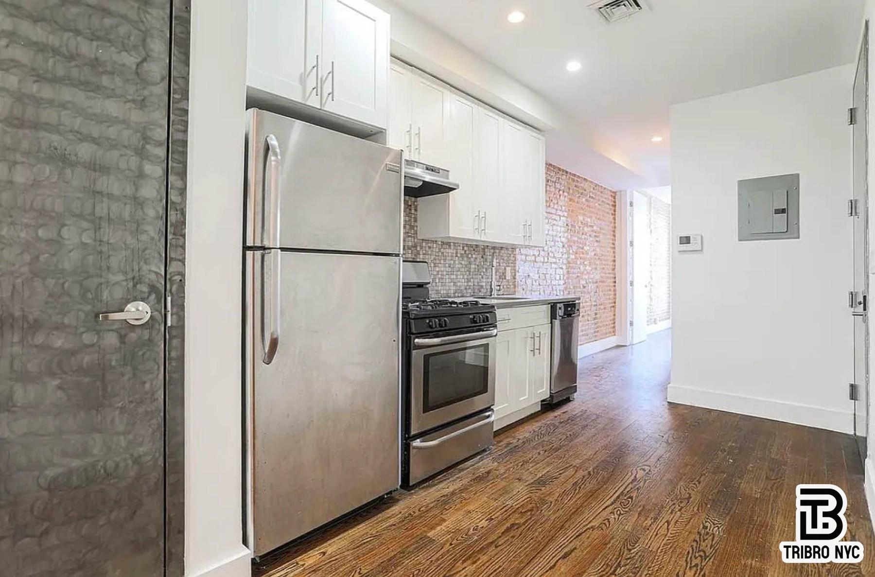 558 Kosciuszko Street, Unit 2R Brooklyn, NY 11221 - Photo 2 of 7 a kitchen with stainless steel appliances a refrigerator and a stove top oven