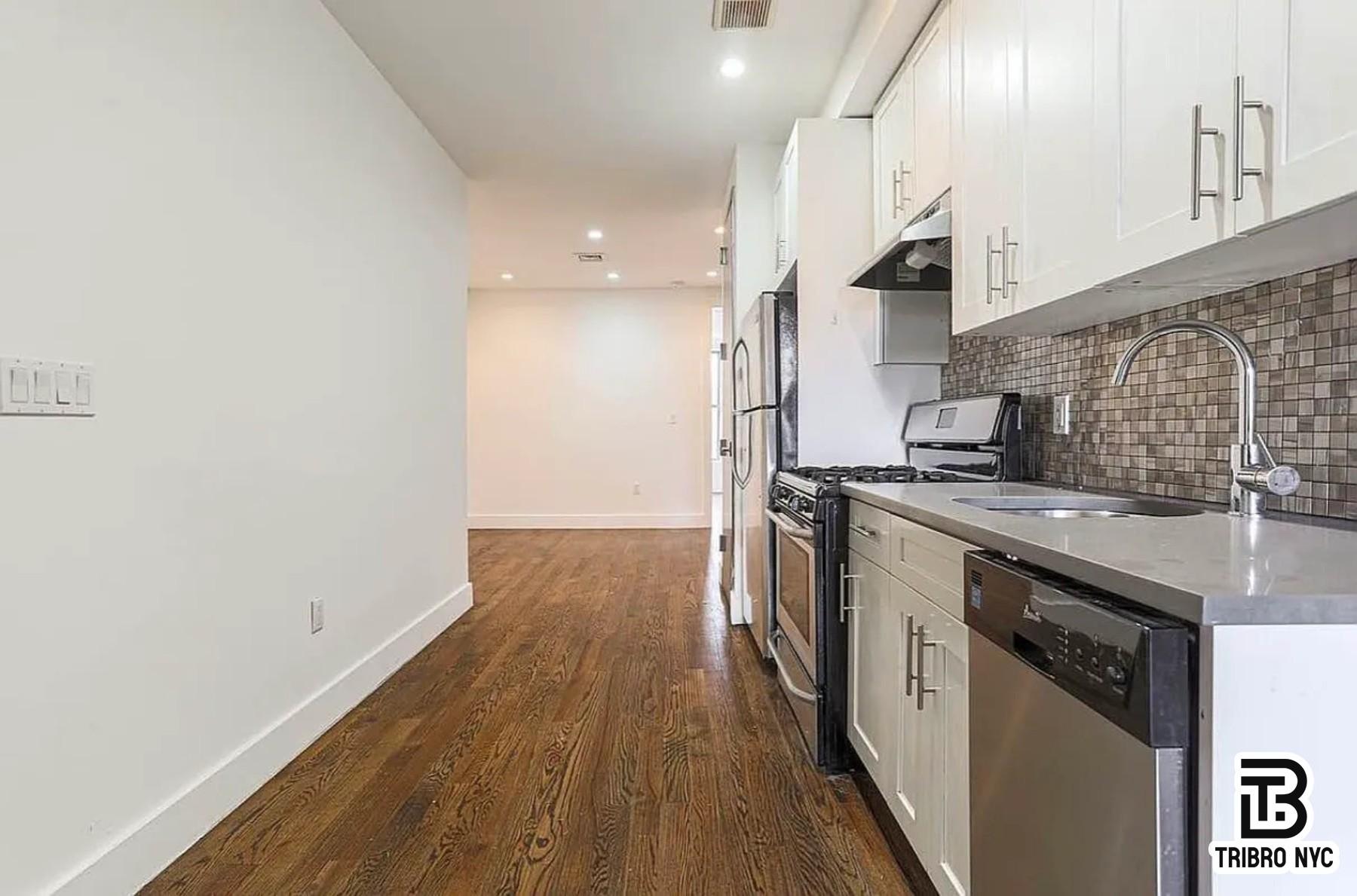 558 Kosciuszko Street, Unit 2R Brooklyn, NY 11221 - Photo 5 of 7 a kitchen with stainless steel appliances granite countertop a stove a sink and a refrigerator