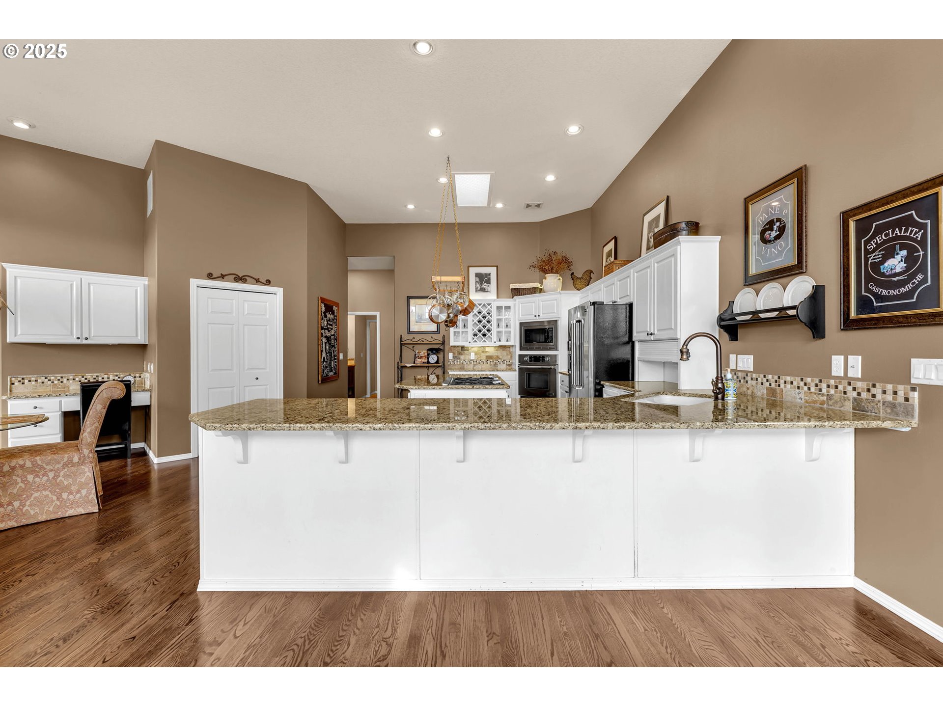 3901 Northwest 150th Circle Vancouver, WA 98685 - Photo 11 of 48 a view of a kitchen with kitchen island a counter top space a sink and appliances