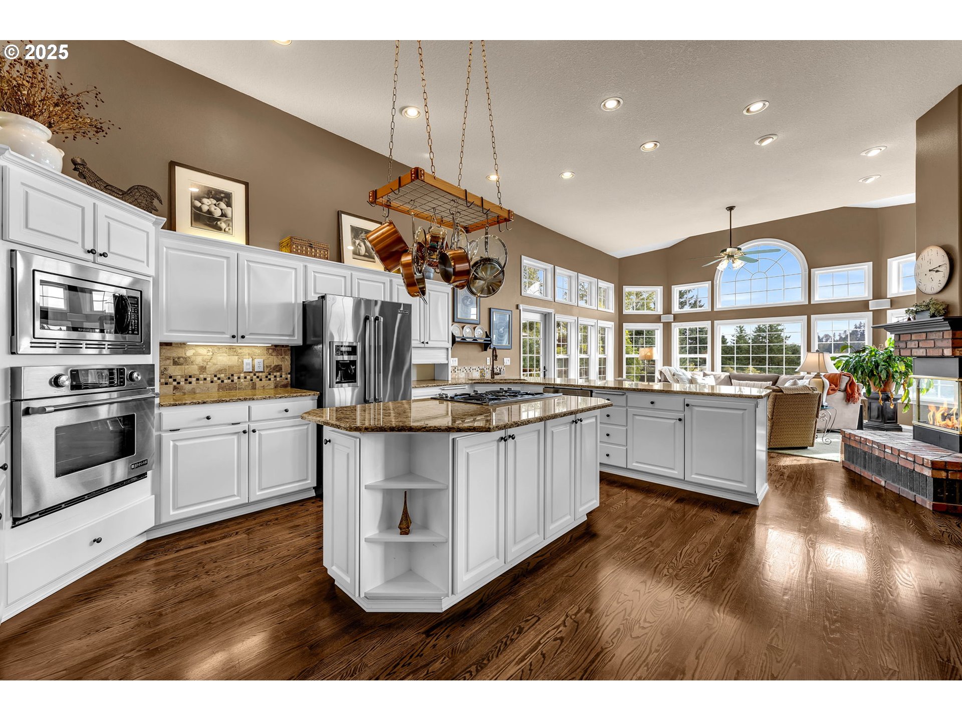 3901 Northwest 150th Circle Vancouver, WA 98685 - Photo 12 of 48 a kitchen with stainless steel appliances kitchen island granite countertop a stove a sink a refrigerator and white cabinets