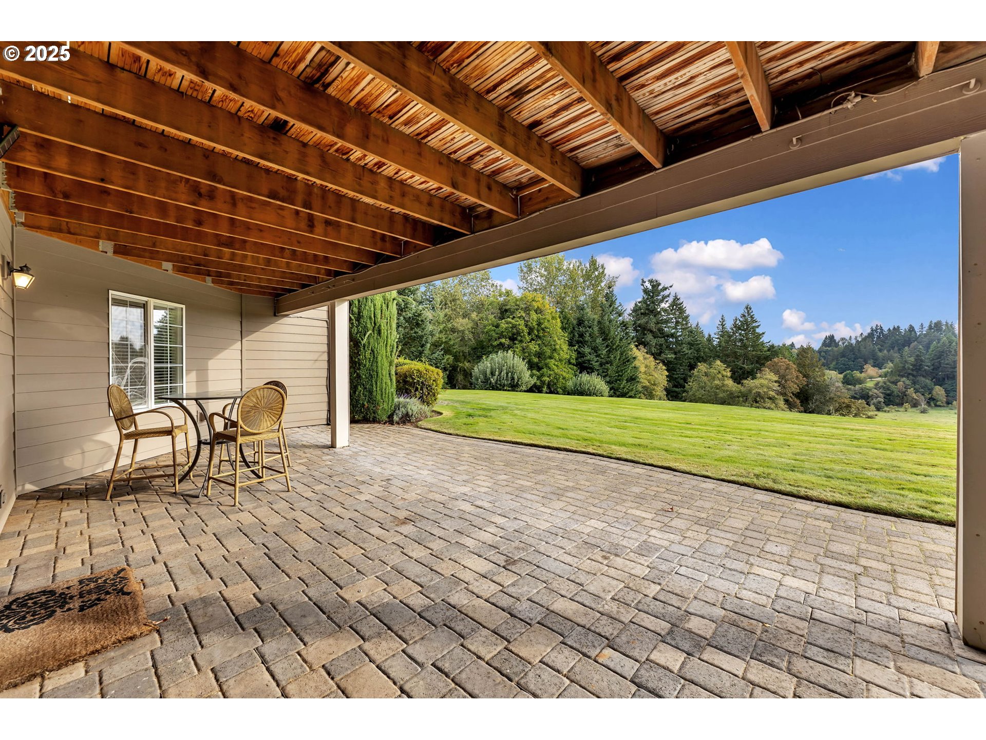 3901 Northwest 150th Circle Vancouver, WA 98685 - Photo 36 of 48 a view of a backyard with table and chairs under an umbrella