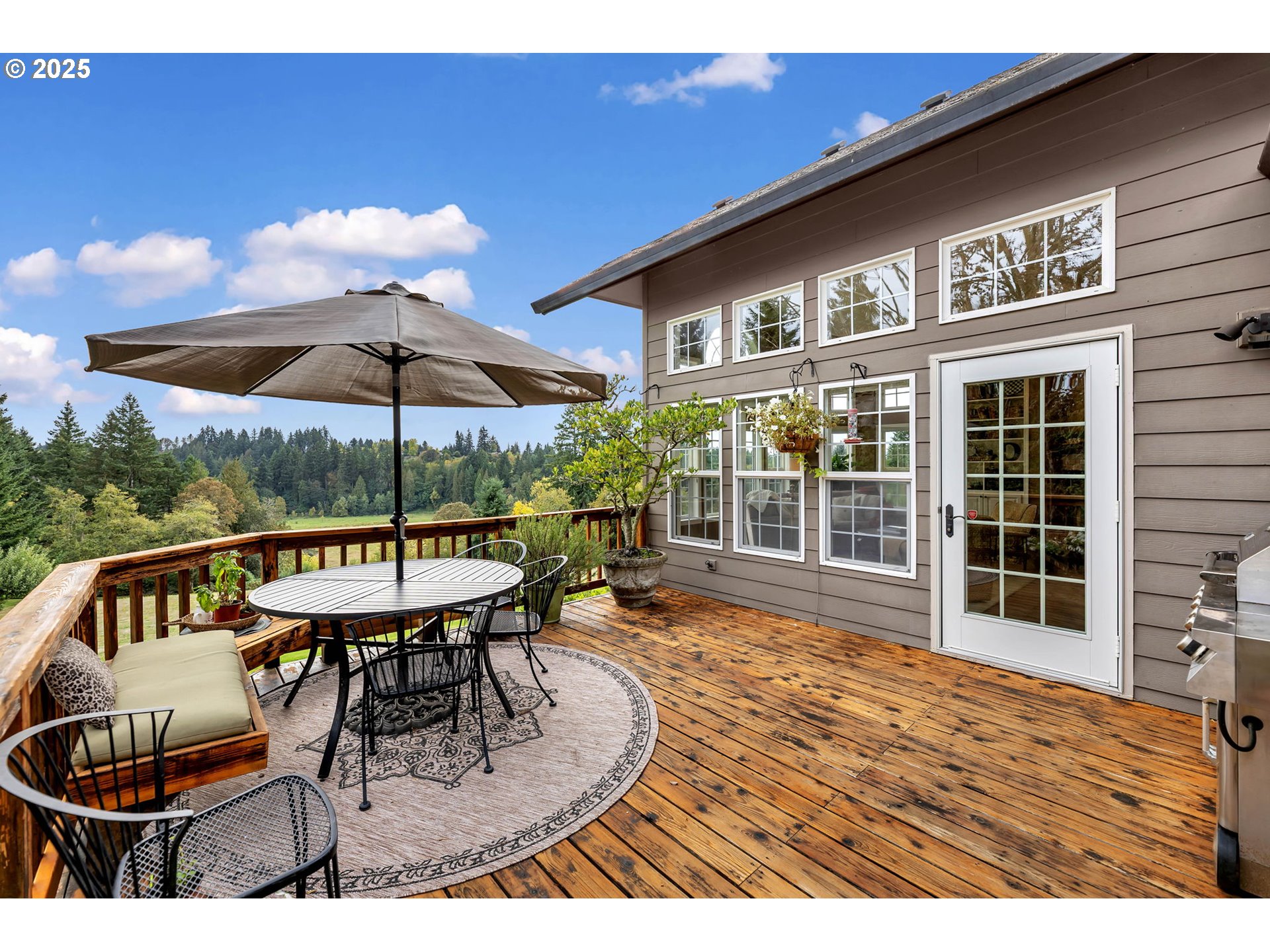 3901 Northwest 150th Circle Vancouver, WA 98685 - Photo 43 of 48 a view of a patio with a table and chairs under an umbrella