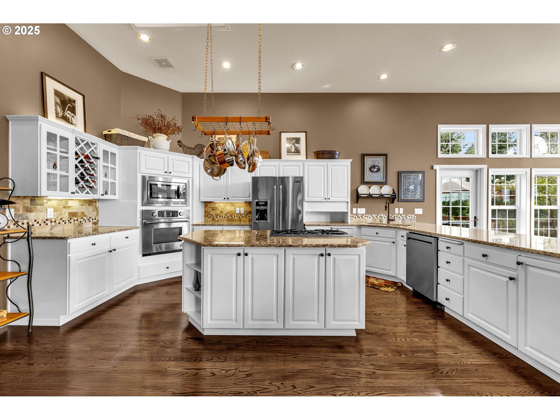 3901 Northwest 150th Circle Vancouver, WA 98685 - Photo 9 of 48 a kitchen with stainless steel appliances kitchen island granite countertop a stove a sink and white cabinets