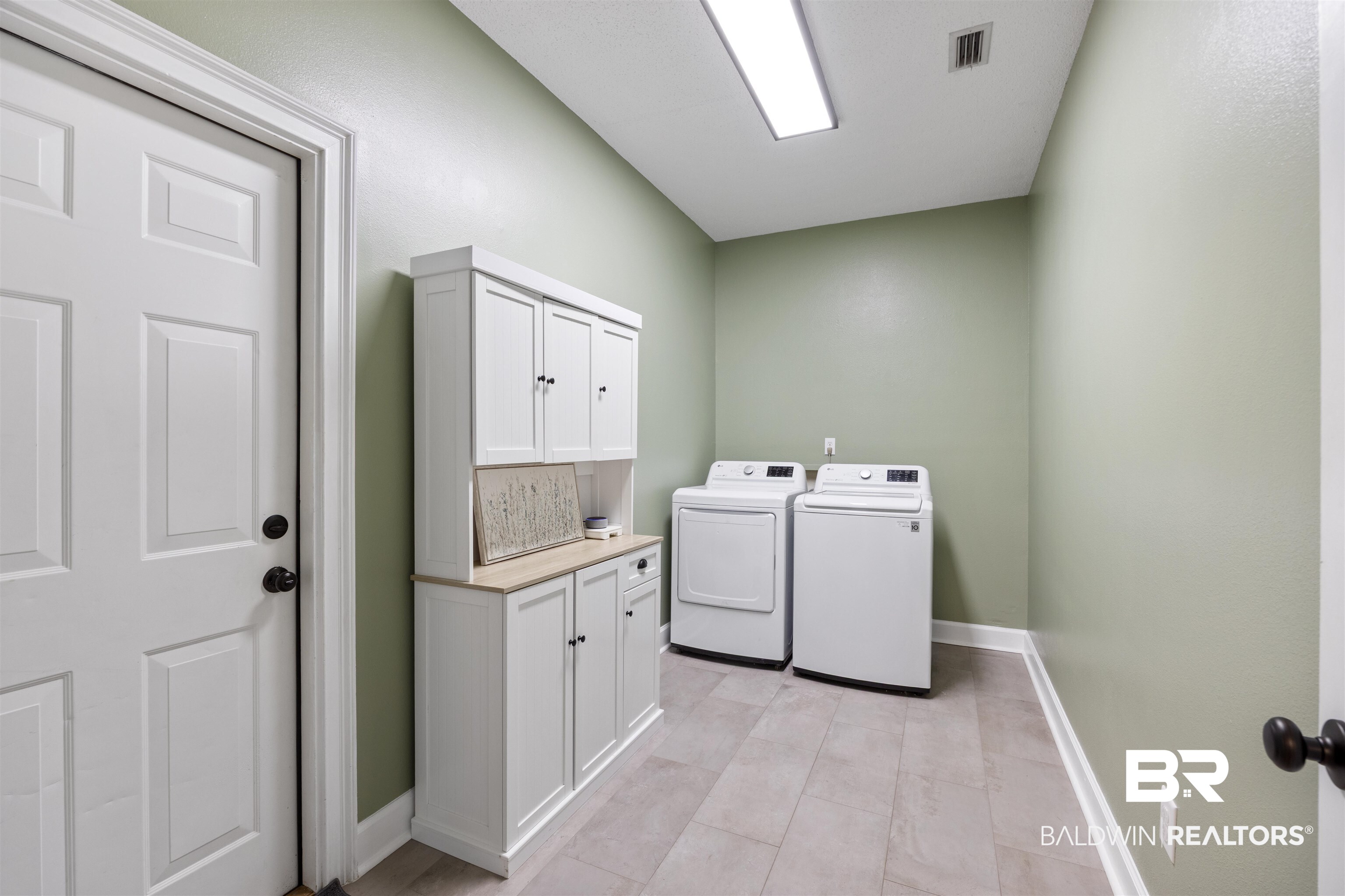 9855 Stucki Road Elberta, AL 36530 - Photo 27 of 54 Laundry area with cabinet space and independent washer and dryer