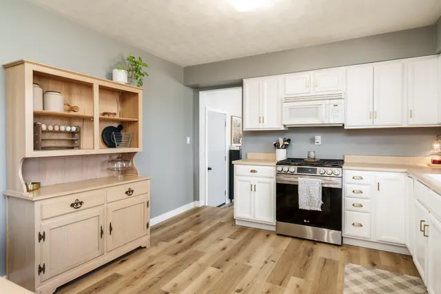 a kitchen with stainless steel appliances granite countertop a refrigerator and a stove