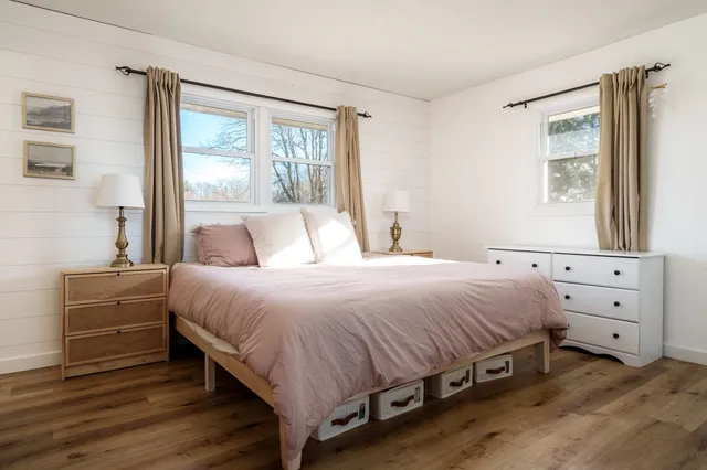 a bedroom with a bed and a mirror