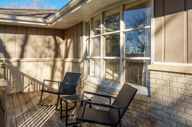 a view of a chairs and table in the balcony