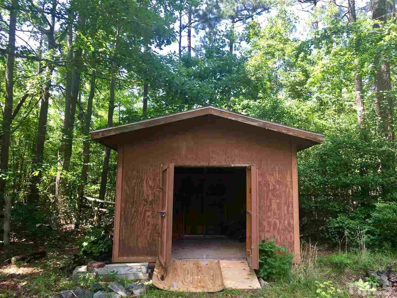1612 Ridge Road Zebulon, NC 27597 - Photo 13 of 17 a front view of a house with a garden