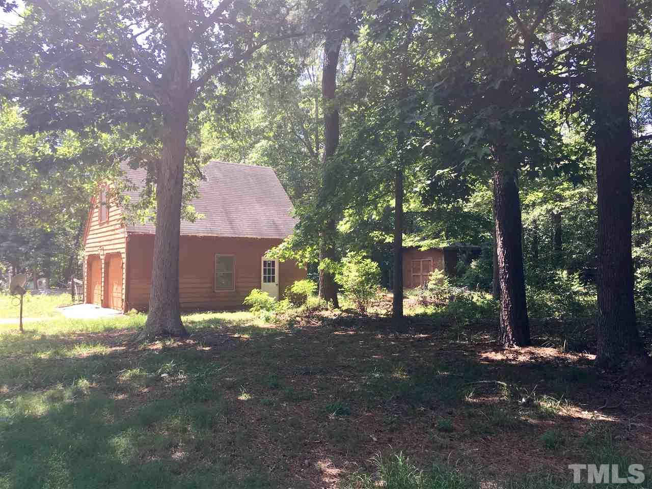 1612 Ridge Road Zebulon, NC 27597 - Photo 2 of 17 a backyard of a house with lots of green space and fountain