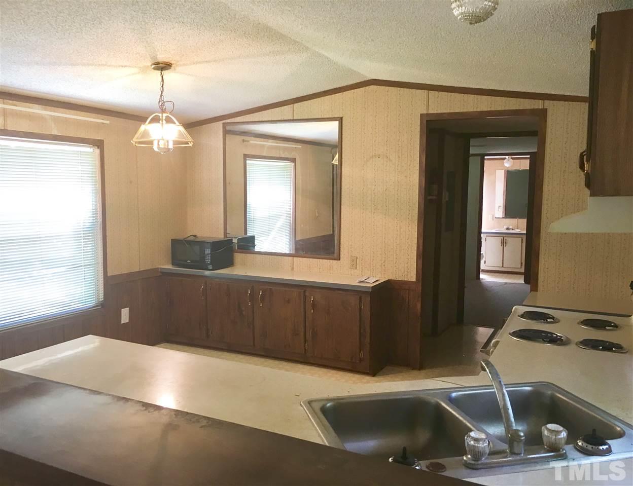 1612 Ridge Road Zebulon, NC 27597 - Photo 3 of 17 a kitchen with a sink appliances and a window