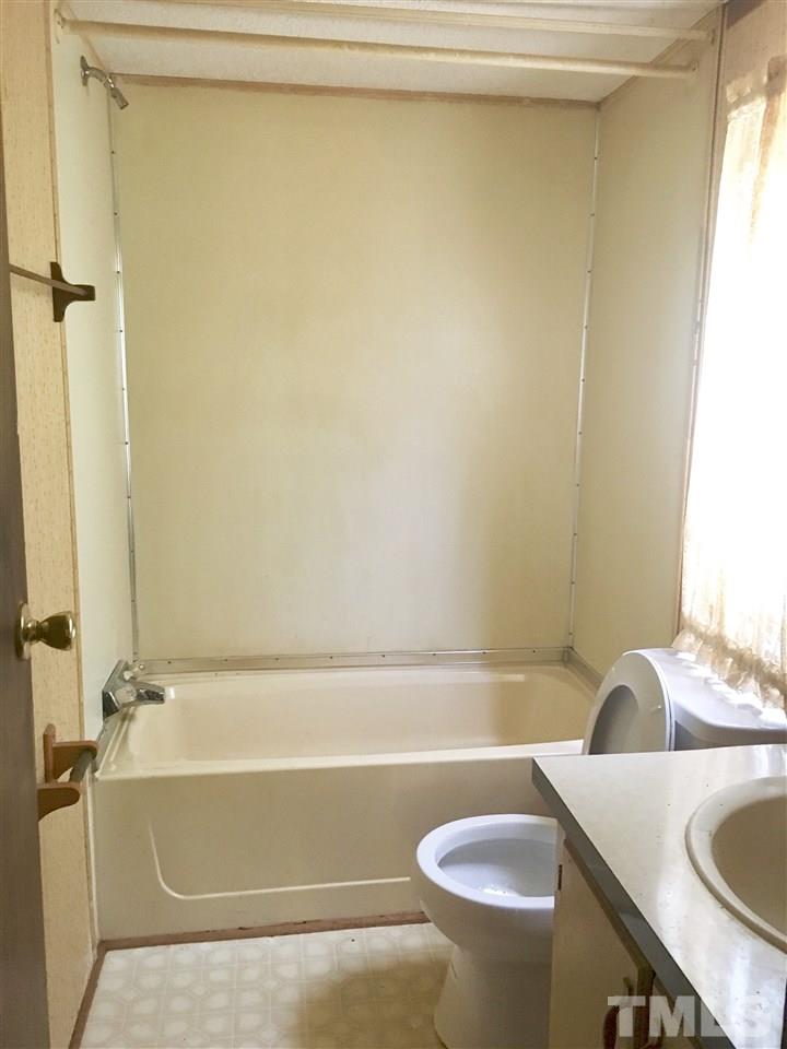 1612 Ridge Road Zebulon, NC 27597 - Photo 4 of 17 a bathroom with a sink and a tub
