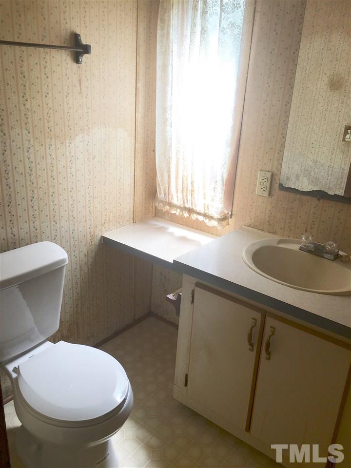 1612 Ridge Road Zebulon, NC 27597 - Photo 7 of 17 a bathroom with a sink and a toilet