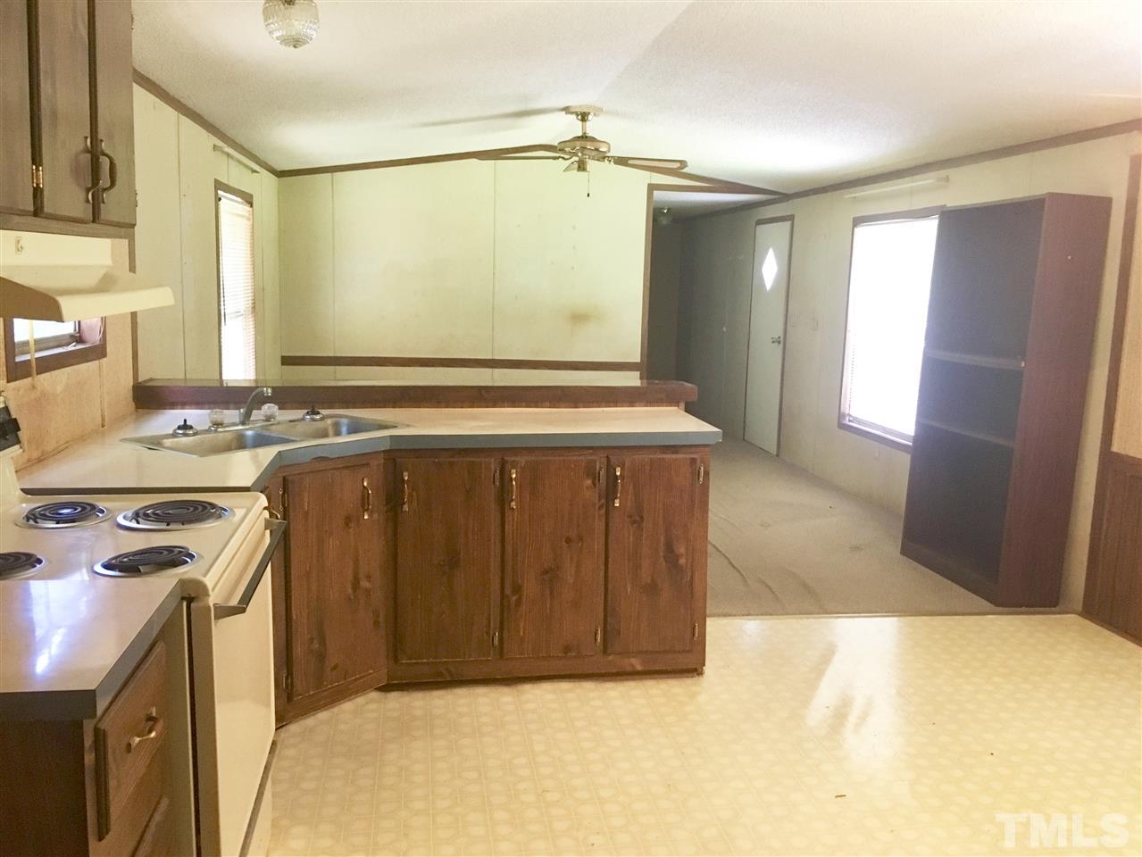 1612 Ridge Road Zebulon, NC 27597 - Photo 8 of 17 a kitchen with a stove a refrigerator and a sink