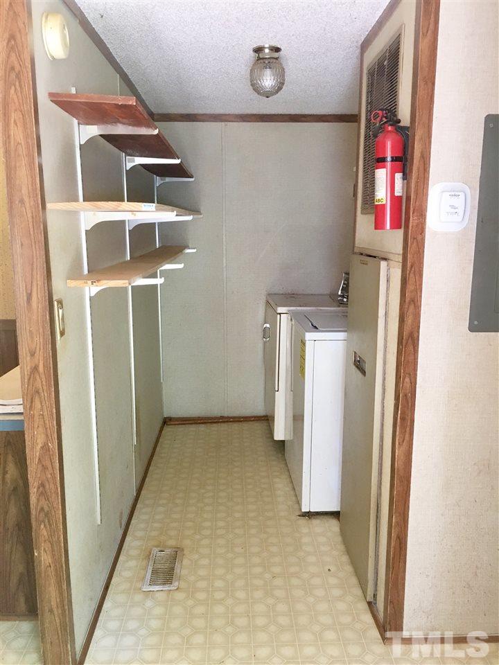 1612 Ridge Road Zebulon, NC 27597 - Photo 10 of 17 a view of walk in closet with clothes and shoes