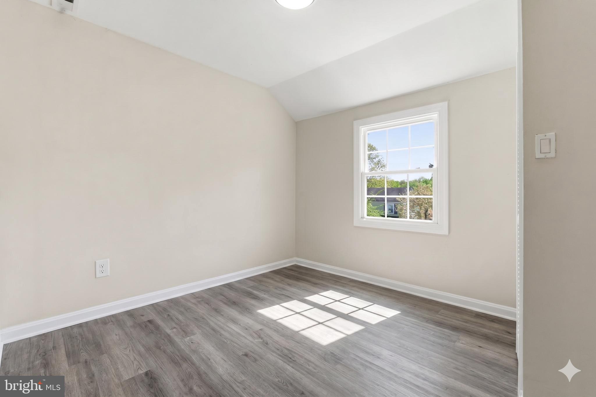 7204 East Inwood Street Landover, MD 20785 - Photo 15 of 24 an empty room with wooden floor and windows