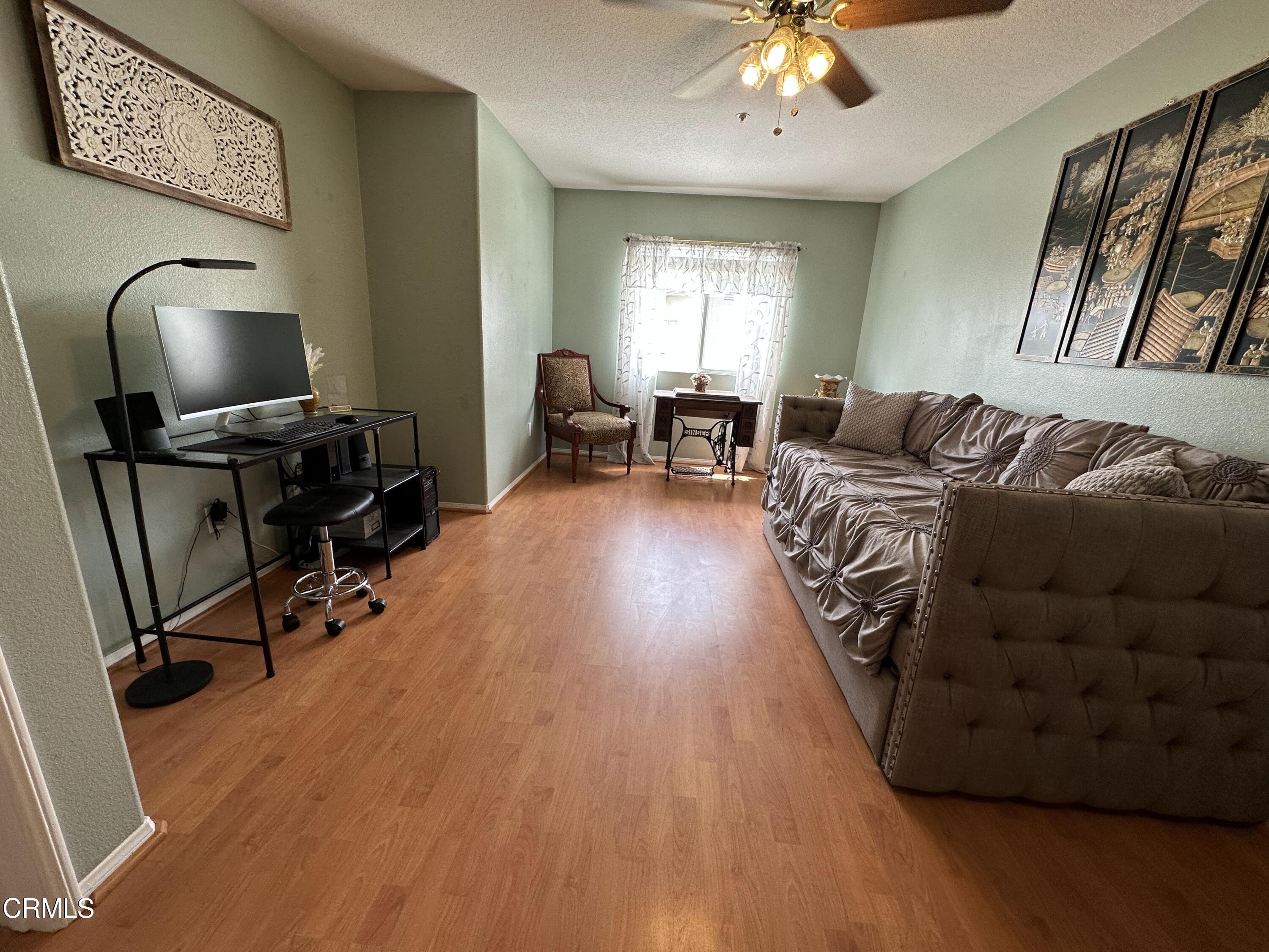 803 Noontide Way Oxnard, CA 93035 - Photo 18 of 26 a living room with furniture and a flat screen tv