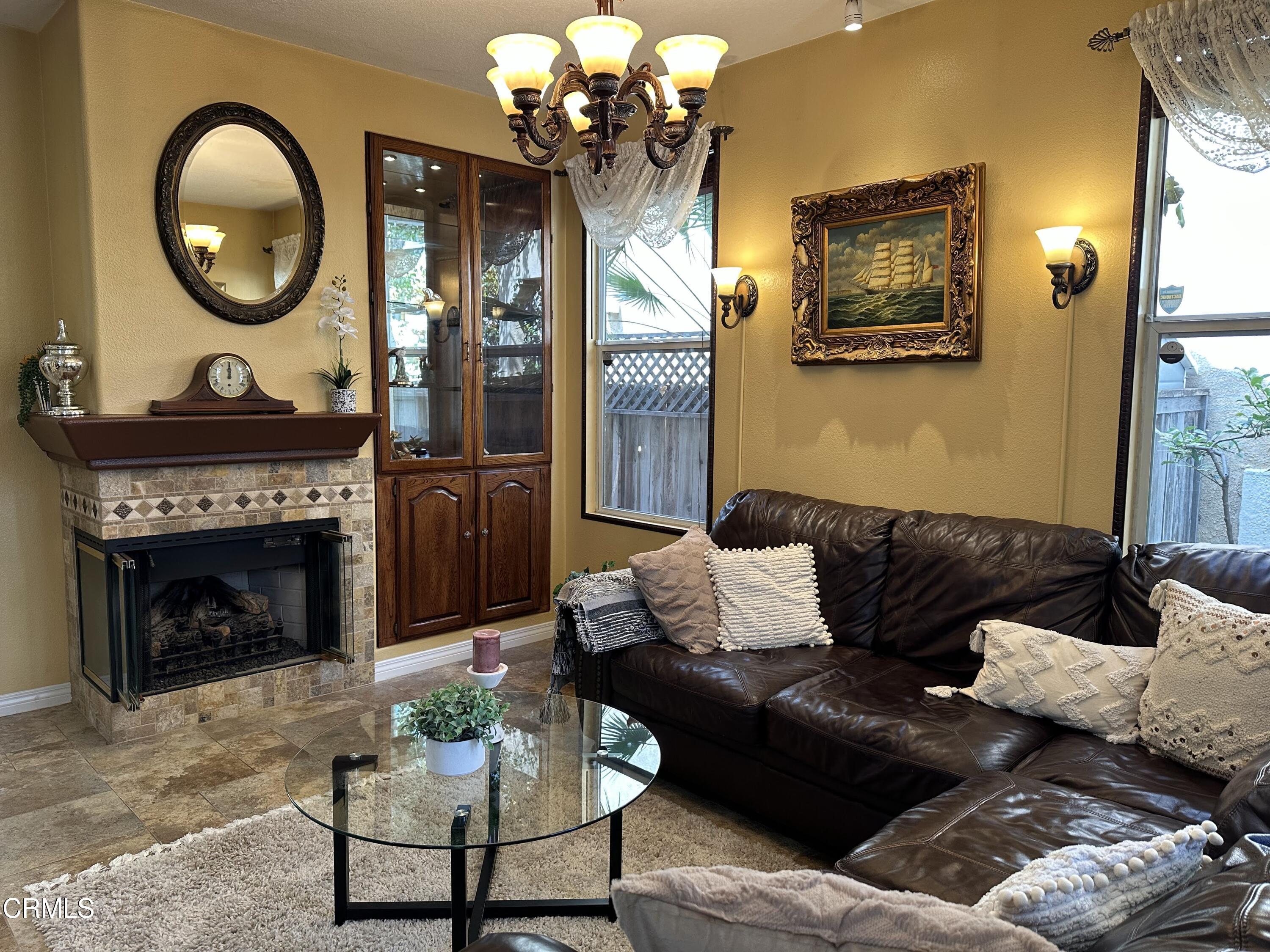 803 Noontide Way Oxnard, CA 93035 - Photo 2 of 26 a living room with furniture a fireplace and a mirror