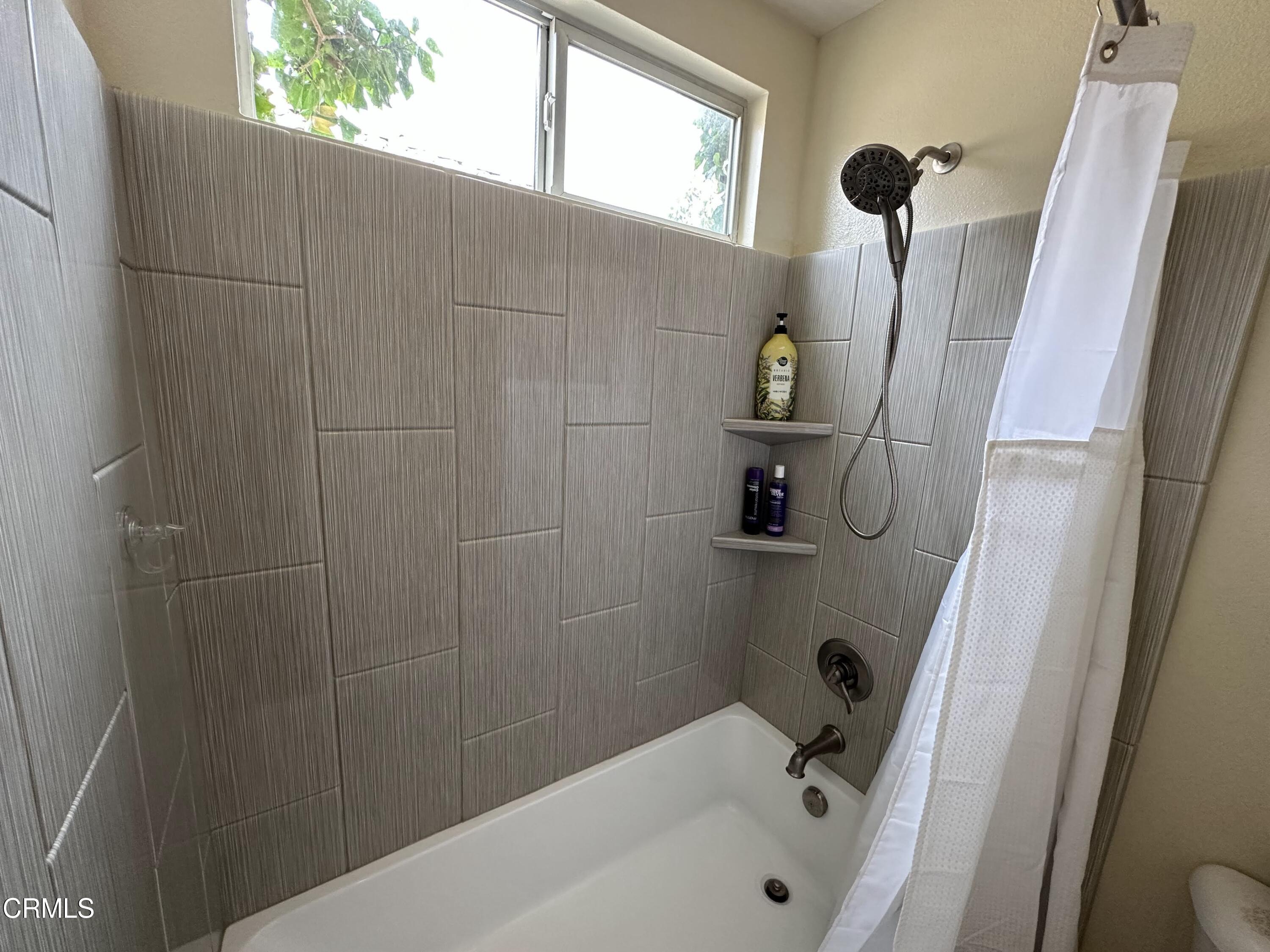 803 Noontide Way Oxnard, CA 93035 - Photo 23 of 26 a bathroom with a window and a shower