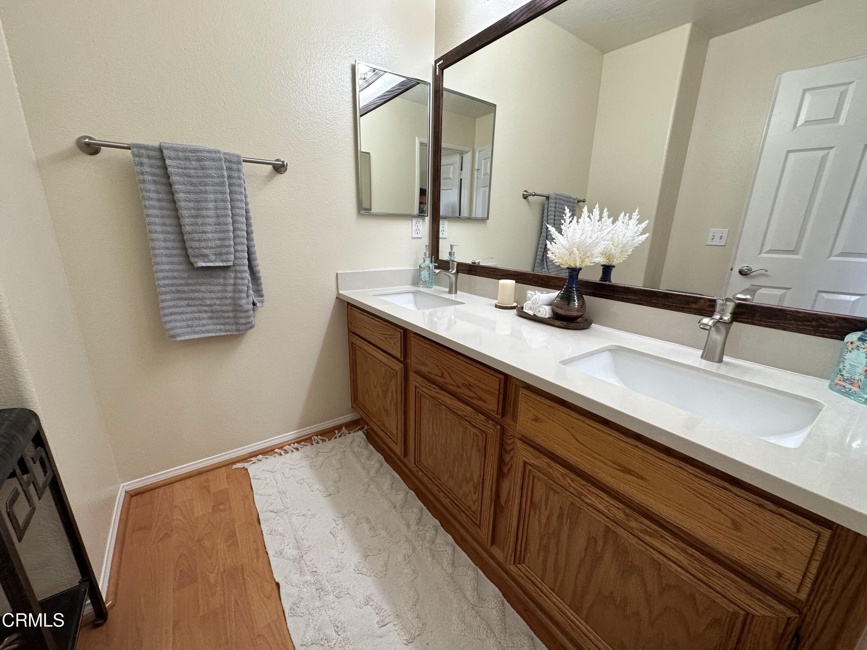 803 Noontide Way Oxnard, CA 93035 - Photo 24 of 26 a bathroom with a sink and a mirror