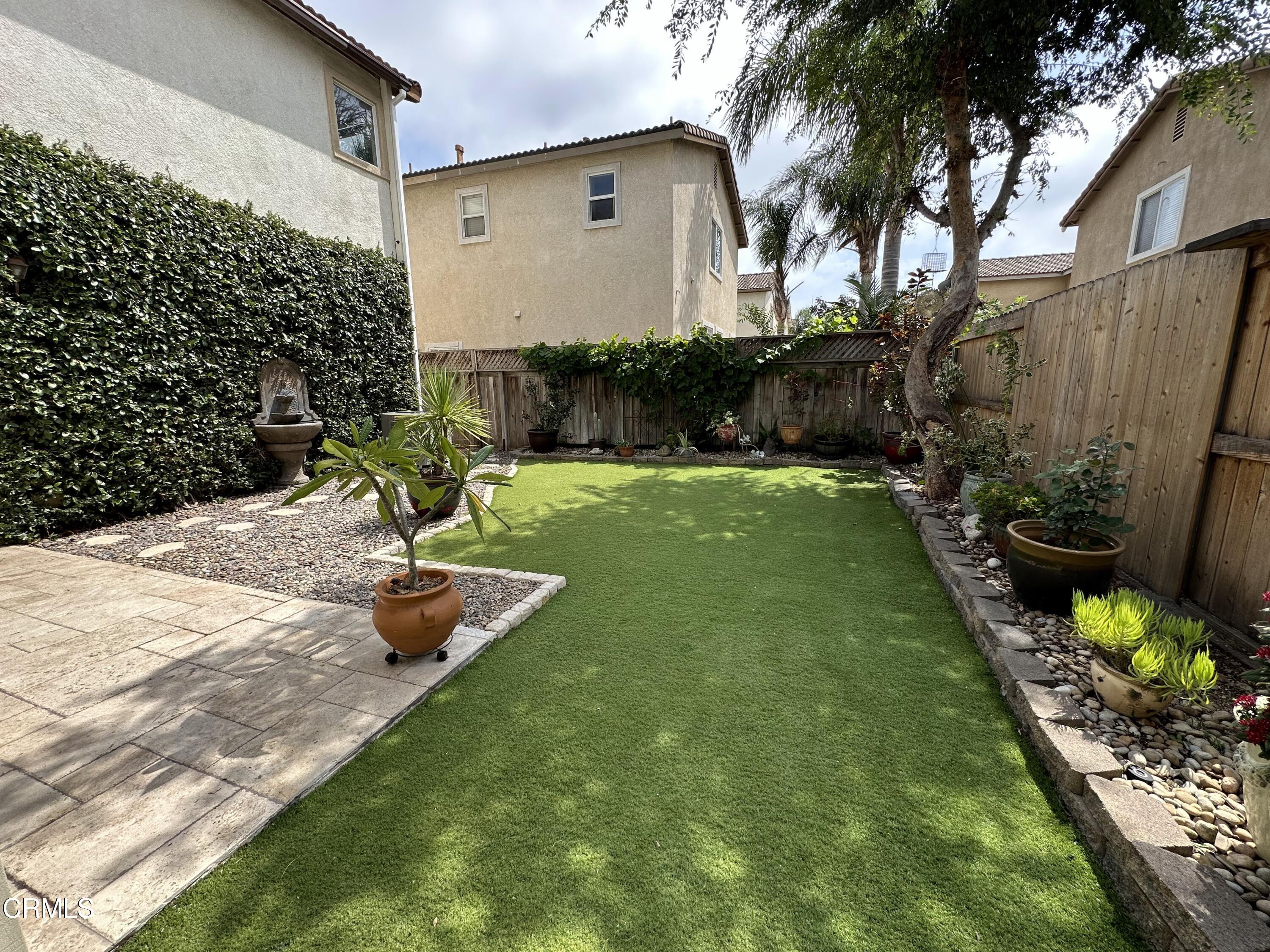 803 Noontide Way Oxnard, CA 93035 - Photo 9 of 26 a backyard of a house with lots of green space