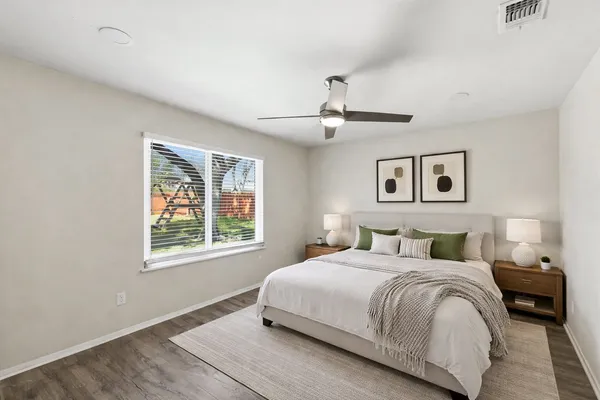 a bedroom with a large bed and a window