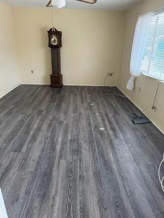 a view of a room with wooden floor and a sink