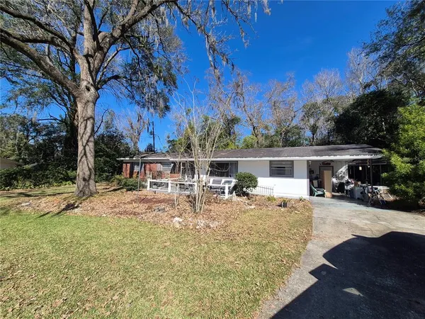 a view of a house with a yard covered with snow in front of house