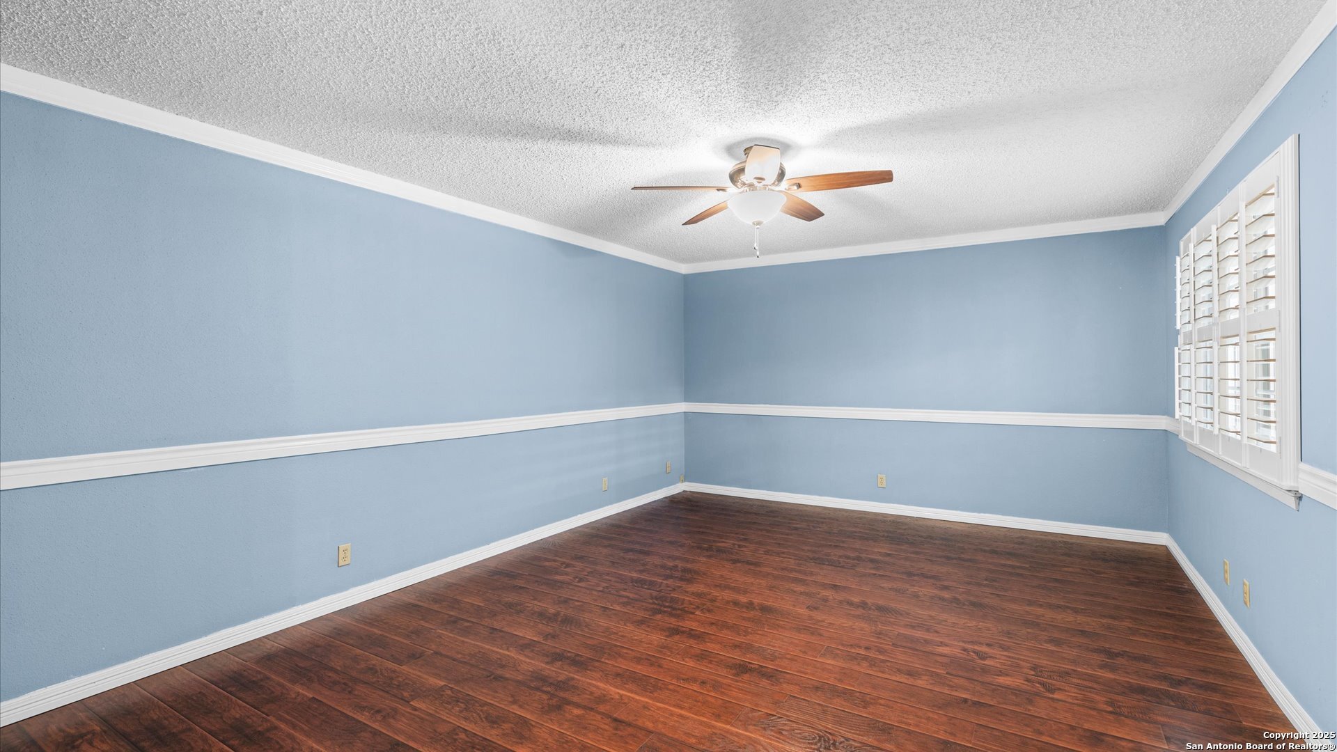 6750 Crown Ridge San Antonio, TX 78239 - Photo 12 of 31 a view of an empty room with a window and wooden floor