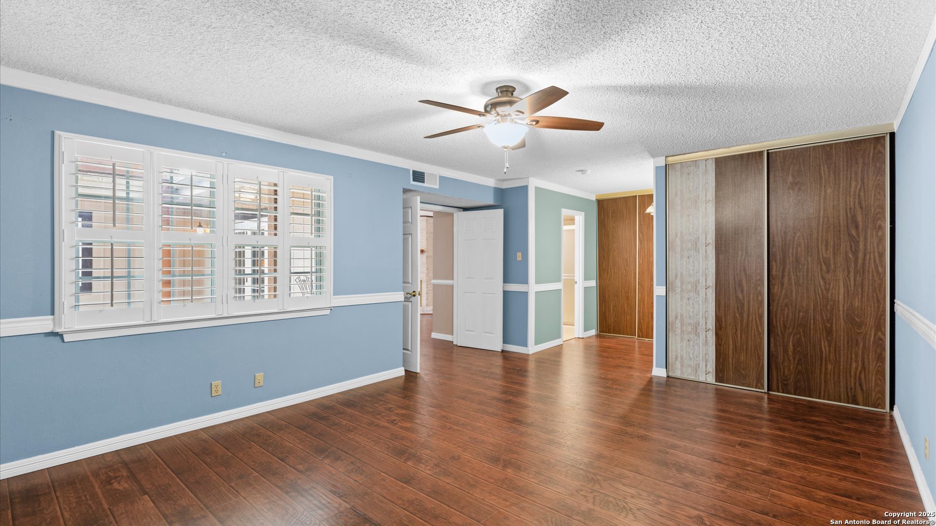 6750 Crown Ridge San Antonio, TX 78239 - Photo 16 of 31 a view of an empty room with wooden floor and a window